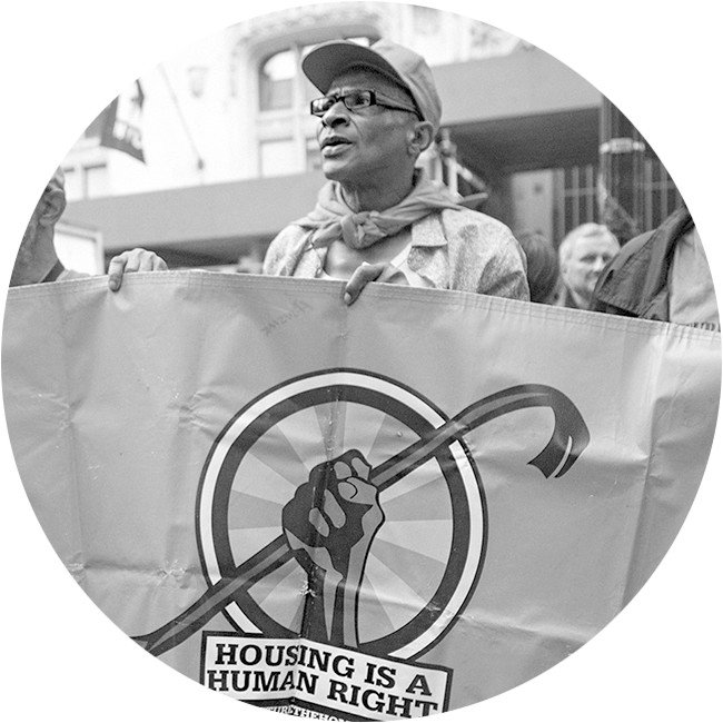 Person holds a sign that says 